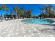 Relaxing community pool with plenty of lounge chairs and a surrounding patio at 5250 Manorwood Dr # 4A, Sarasota, FL 34235