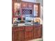 Wet bar with granite countertop and wood cabinetry at 5250 Manorwood Dr # 4A, Sarasota, FL 34235