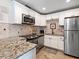 Modern white kitchen with granite countertops and appliances at 5508 Dinah Ln, Sarasota, FL 34231