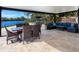 Covered patio with seating area, overlooking canal at 5508 Dinah Ln, Sarasota, FL 34231