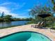 Inviting kidney-shaped pool with patio and tranquil water views at 5508 Dinah Ln, Sarasota, FL 34231