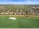 Sweeping aerial view showcasing the community with golf course, lakes, and lush landscaping against a clear blue sky at 5527 Palmer Cir # 205, Bradenton, FL 34211