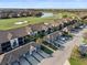 Panoramic aerial view of condos, golf course, and lake, showcasing the community's serene and picturesque setting at 5527 Palmer Cir # 205, Bradenton, FL 34211