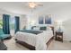 Bright bedroom features white walls, blue accents, and a ceiling fan for comfortable living at 5527 Palmer Cir # 205, Bradenton, FL 34211