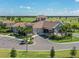 Stunning clubhouse with a beautiful tile roof, golf course views and lush landscaping at 5527 Palmer Cir # 205, Bradenton, FL 34211