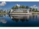 Elegant stone entrance sign 'Lakewood National' reflected in a tranquil pond surrounded by meticulously landscaped grounds at 5527 Palmer Cir # 205, Bradenton, FL 34211