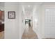 Bright hallway featuring neutral paint, tile flooring, and decorative accents, offering a welcoming entrance to the home at 5527 Palmer Cir # 205, Bradenton, FL 34211