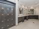 Upscale locker room with gray lockers, tile flooring, sinks, mirrors and ample counter space at 5527 Palmer Cir # 205, Bradenton, FL 34211