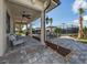 Outdoor patio showcasing pavers, ceiling fans, and views of the community tennis courts at 5527 Palmer Cir # 205, Bradenton, FL 34211