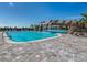 Community pool with rock waterfall feature surrounded by lush landscaping and lounge seating at 5527 Palmer Cir # 205, Bradenton, FL 34211