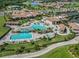 Aerial view of resort-style pool with waterfalls, lush landscaping, and plenty of lounge chairs for relaxation at 5527 Palmer Cir # 205, Bradenton, FL 34211