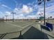 Active community with multiple well-maintained tennis courts under the bright blue sky and puffy clouds at 5527 Palmer Cir # 205, Bradenton, FL 34211