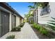 Charming walkway lined with lush landscaping and tropical palm trees, creating a welcoming entrance to the condos at 5527 Palmer Cir # 205, Bradenton, FL 34211