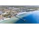 Wide aerial shot showcasing the coastline and condos, complemented by a pier and beachfront amenities at 559 Bahia Beach Blvd, Ruskin, FL 33570