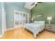 Comfortable bedroom featuring shuttered balcony doors, vaulted ceilings, and beach-themed decor at 559 Bahia Beach Blvd, Ruskin, FL 33570