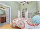 A bedroom with a vaulted ceiling, open bathroom doorway, and bright lighting at 559 Bahia Beach Blvd, Ruskin, FL 33570