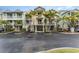 Quaint multi-story townhomes adorned with palm trees, offering covered parking and private balconies at 559 Bahia Beach Blvd, Ruskin, FL 33570