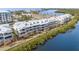 Waterfront condos boast multiple balconies with scenic views, complemented by meticulous landscaping along the shore at 559 Bahia Beach Blvd, Ruskin, FL 33570