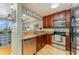 Kitchen featuring stainless steel appliances and breakfast bar, open to living room at 559 Bahia Beach Blvd, Ruskin, FL 33570