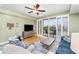 Comfortable living room featuring sliding glass doors to balcony, ceiling fan and stylish decor at 559 Bahia Beach Blvd, Ruskin, FL 33570