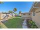 Landscaped backyard featuring a well-kept lawn, stepping stones, and privacy fence at 5713 Saint Louis Ave, Sarasota, FL 34233