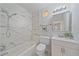 Bright bathroom with marble tile shower/tub, modern vanity, and neutral color palette at 5713 Saint Louis Ave, Sarasota, FL 34233