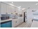 Renovated kitchen with white cabinets, modern backsplash, stainless steel appliances, and sleek black hardware at 5713 Saint Louis Ave, Sarasota, FL 34233