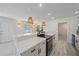 Beautiful open kitchen featuring pendant lighting, quartz counters, and stainless steel appliances at 5713 Saint Louis Ave, Sarasota, FL 34233