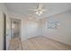 Main bedroom with new floors, white ceiling fan, large closet and an open doorway at 5713 Saint Louis Ave, Sarasota, FL 34233