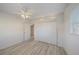 Main bedroom with new floors, white ceiling fan, large closet and view to the hallway at 5713 Saint Louis Ave, Sarasota, FL 34233