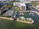 Stunning aerial view of the harbor, surrounding condos, and complex tennis courts at 5855 Midnight Pass Rd # 233, Sarasota, FL 34242