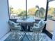 Outdoor balcony with table and chairs and view of the complex pool at 5855 Midnight Pass Rd # 233, Sarasota, FL 34242