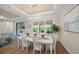 Elegant dining room featuring a farmhouse table, chandelier, and natural light at 5892 Semolino St, Nokomis, FL 34275