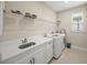 Laundry room with sink, cabinets, and shelving at 5892 Semolino St, Nokomis, FL 34275