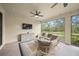 Relaxing screened porch with seating area and large TV at 5892 Semolino St, Nokomis, FL 34275