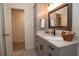 Modern bathroom with gray vanity, patterned floor, and large mirror at 603 Saint Andrews Dr, Sarasota, FL 34243