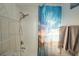 Bathroom with shower/tub combo and beach-themed decor at 603 Saint Andrews Dr, Sarasota, FL 34243