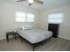 Bright bedroom with double bed, dresser, and ceiling fan at 603 Saint Andrews Dr, Sarasota, FL 34243