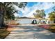 Single-story home with attached garage, landscaping, and a long driveway at 603 Saint Andrews Dr, Sarasota, FL 34243