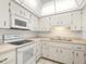 White kitchen with stainless steel appliances and microwave at 6091 Coral Way, Bradenton, FL 34207