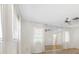 Living room featuring hardwood floors, mirrored wall, and ceiling fan at 6091 Coral Way, Bradenton, FL 34207