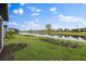 Waterfront backyard with lush grass and pond view at 6240 Fish Eagle Ct, Nokomis, FL 34275