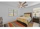 Bedroom with ceiling fan and large window, wooden bed frame and ensuite bathroom at 6240 Fish Eagle Ct, Nokomis, FL 34275