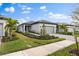 Single story home with gray garage door and landscaping. Beautiful curb appeal at 6240 Fish Eagle Ct, Nokomis, FL 34275