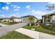 A home's exterior showcasing a paver driveway, landscaping, and a green lawn at 6240 Fish Eagle Ct, Nokomis, FL 34275