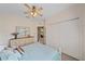 Cozy bedroom with light blue bedding and ceiling fan at 6334 Grand Oak Cir # 201, Bradenton, FL 34203