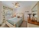 Charming bedroom with light blue bedding and ceiling fan at 6334 Grand Oak Cir # 201, Bradenton, FL 34203