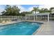 Refreshing community swimming pool with shaded seating at 6334 Grand Oak Cir # 201, Bradenton, FL 34203