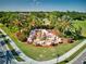 Aerial view of River Strand community entrance with lush landscaping and a waterfall feature at 6814 Willowshire Way, Bradenton, FL 34212