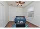 Cozy guest room features a blue sofa, wood floors, and a window with blinds at 6814 Willowshire Way, Bradenton, FL 34212